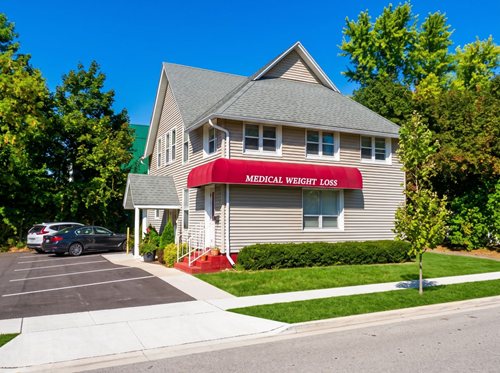 The Medical Weight Loss office, a two-story building with a red awning over the entrance.